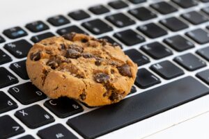 What are web cookies shown as a chocolate chip cookie on a laptop keyboard